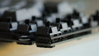 Properly seated switches sit flat on the plate with a small gap between the plate and PCB.